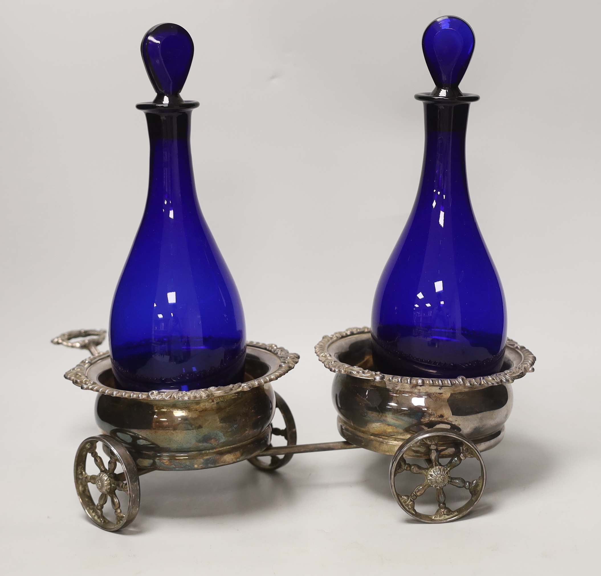 A plated twin coaster trolley and two Bristol blue decanters, trolley 43cm long